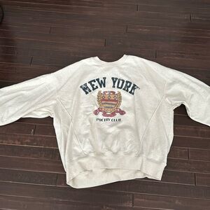 An oversized crewneck, lightly worn